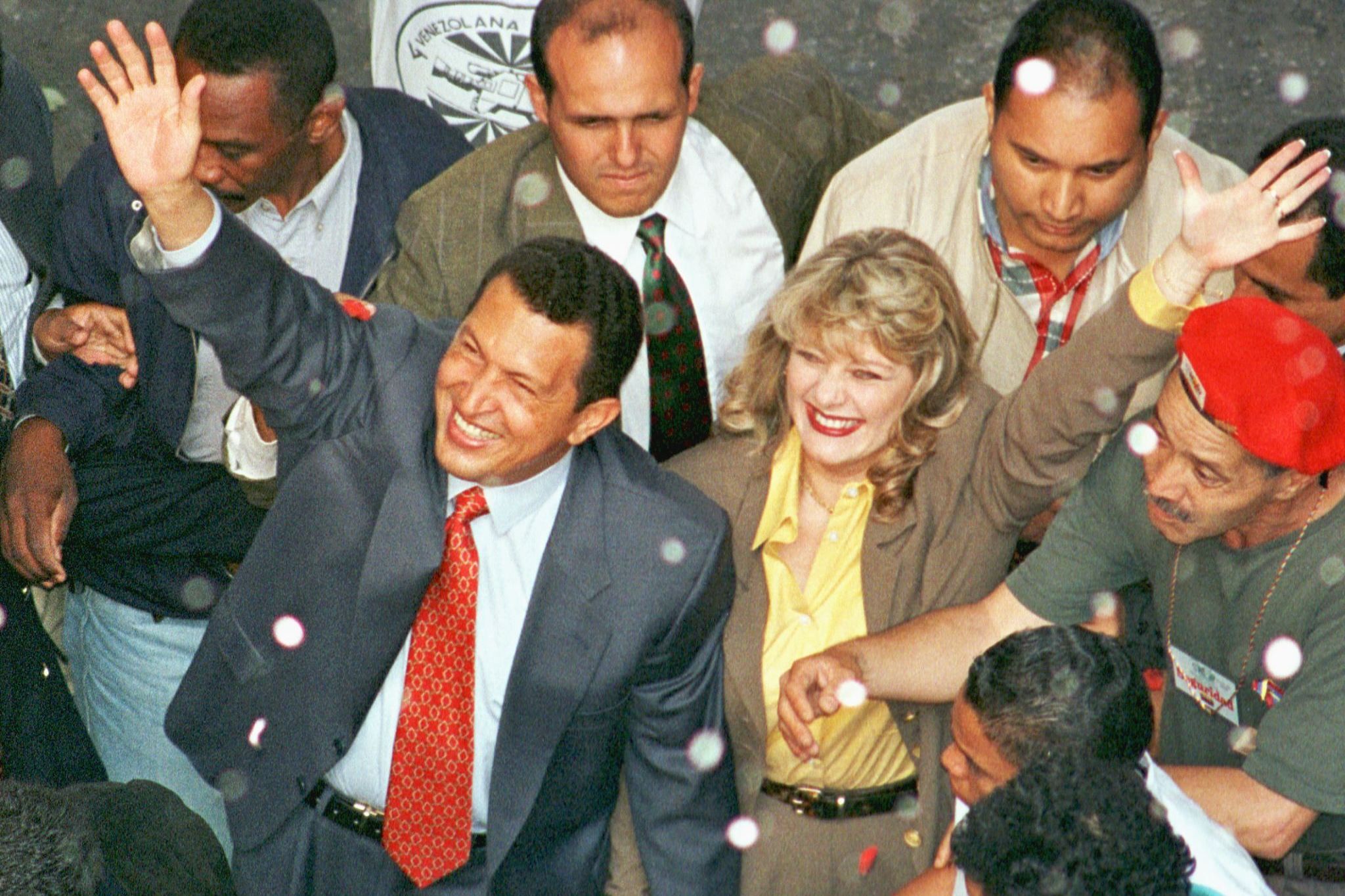 Chavez and his wife, Marisabel, wave to supporters in July 1998, as Chavez arrives at the National Electoral Council to register for the presidential election. He won the election by a landslide.