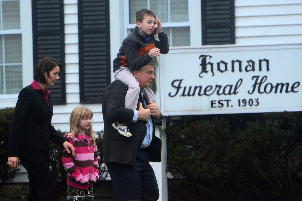Mourners leave the Honan funeral home after attending the funeral of Jack Pinto, 6, one of the victims of the Sandy Hook Elementary School shootings, in Newtown, Conn.