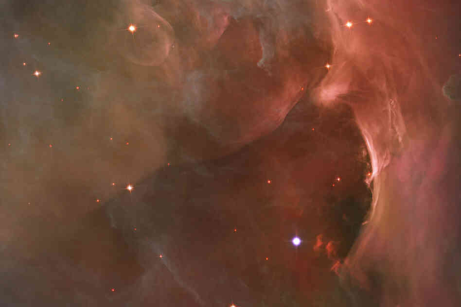 "This glowing region reveals arcs and bubbles formed when stellar winds ... collide with material in the Orion Nebula."