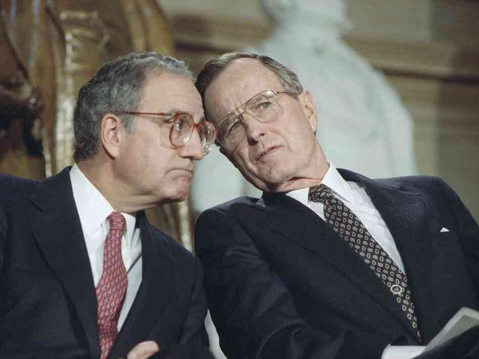 President George H.W. Bush, seen with Senate Majority Leader George Mitchell, D-Maine, in 1991, was punished at the ballot box for compromises that produced a budget-reduction act in 1990.