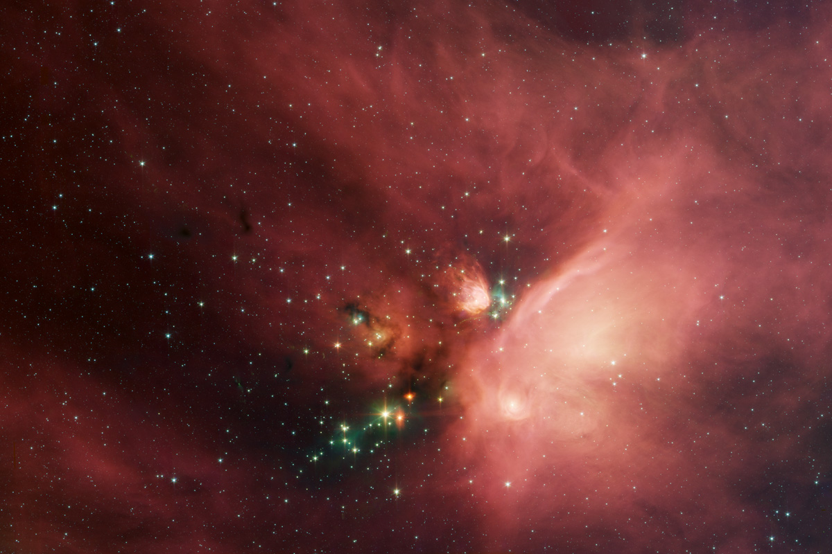 "This image of the Rho Ophiuchi dark cloud ... shows newborn stars peeking out from beneath a dust blanker."