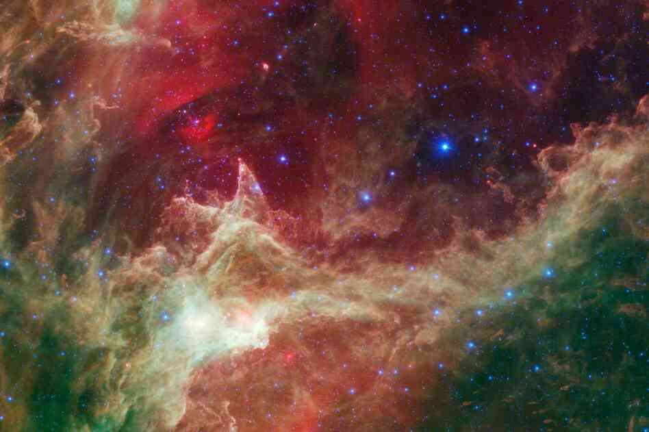 "In this wispy star-forming region, called W5, the oldest stars can be seen as blue dots in the centers of the two hollow cavities. ... Younger stars line the rims of the cavities, and some can be seen as pink dots at the tips of the elephant-trunklike pillars."