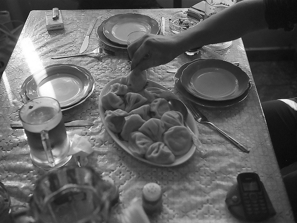 Eating lamb dumplings called khinkali at a table in Tbilisi, Georgia.