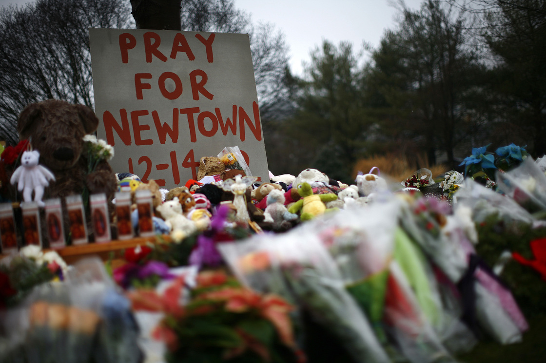 Flowers, candles and stuffed animals make up a makeshift memorial in Newtown, Conn., on Monday. Much of the initial news coverage of Friday's events was later found to be inaccurate.