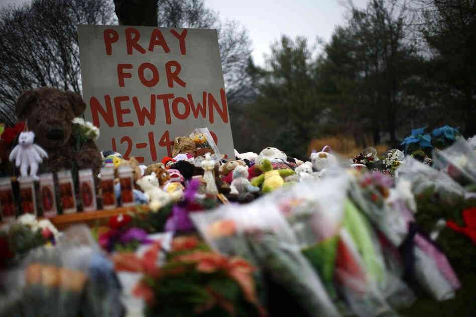 Flowers, candles and stuffed animals make up a makeshift memorial in Newtown, Conn., on Monday. Much of the initial news coverage of Friday's events was later found to be inaccurate.