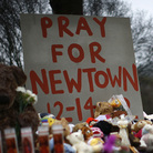 Flowers, candles and stuffed animals make up a makeshift memorial in Newtown, Conn., on Monday. Much of the initial news coverage of Friday's events was later found to be inaccurate.