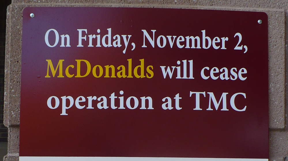 A sign outside an entrance at the Truman Medical Centers' main campus in Kansas City, Mo., announces the closure of the McDonald's located on-site.