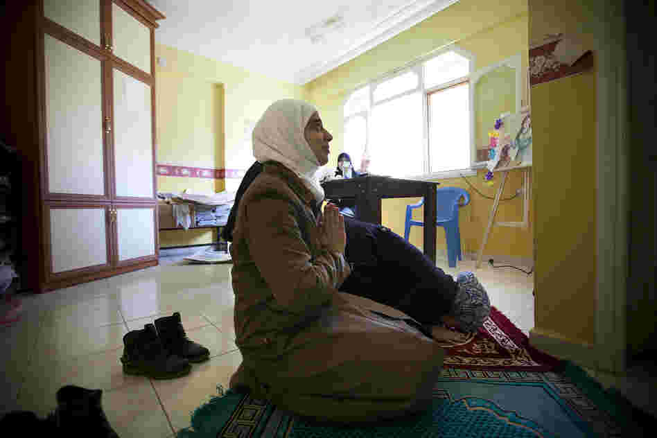 Teachers at the school are mostly devout Muslims. Between classes, teachers Rahaf Al Tinawie and Rola Kadi take a break to pray.
