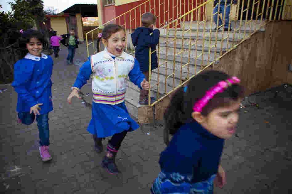 Children play during recess. The school is overcrowded with 500 students and new students constantly arriving. In one recent week, 115 new students enrolled.