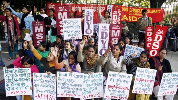 Indian women and children in New Delhi stage a protest Tuesday to condemn the gang rape of a 23-year-old student on a city bus.