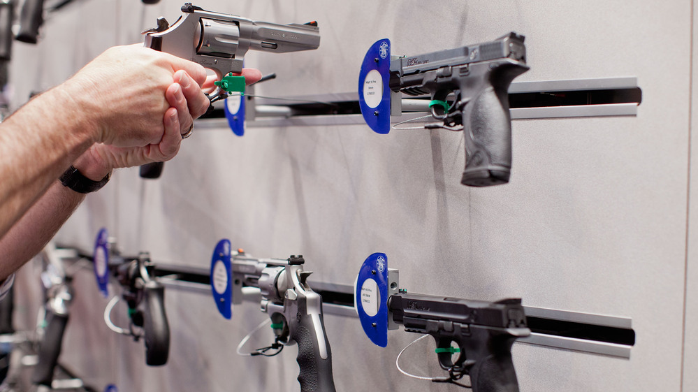 A visitor handles a revolver at a Smith & Wesson display during the NRA Annual Meetings and Exhibits on April 14 at America's Center in St. Louis, Mo.
