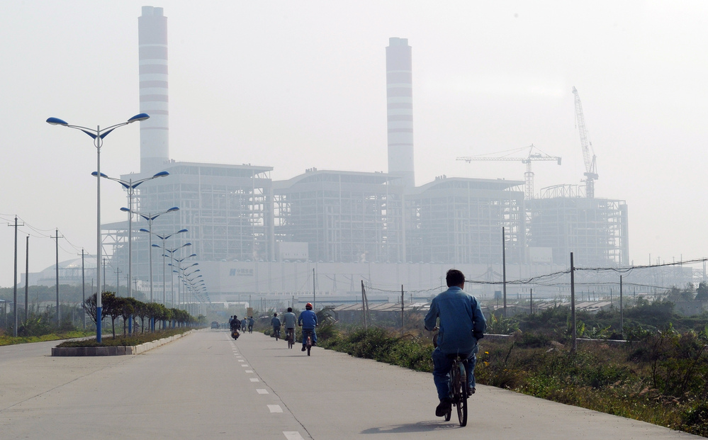 China and India are projected to propel coal's challenge of oil as the world's top energy source within the next five years, according to a new study. Here, a man rides a bicycle toward a coal-fired power station in China's Guangdong province last year. China and India are projected to propel coal's challenge of oil as the world's top energy source within the next five years, according to a new study. Here, a man rides a bicycle toward a coal-fired power station in China's Guangdong province last year.