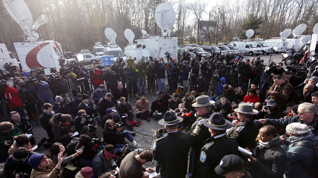 Lt. J. Paul Vance of the Connecticut State Police conducts a news briefing Saturday in Newtown, Conn. The strategy for dealing with the wave of news media in Newtown echoes that of some past tragedies, experts say.