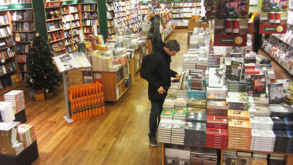 A shopper browses in a branch of the Icelandic book chain Penninn-Eymundsson.
