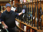 At the Freddie Bear Sports shop in Tinley Park, Ill., Jason Zielinski shows AR-15 style rifles to a customer. At the Freddie Bear Sports shop in Tinley Park, Ill., Jason Zielinski shows AR-15 style rifles to a customer.