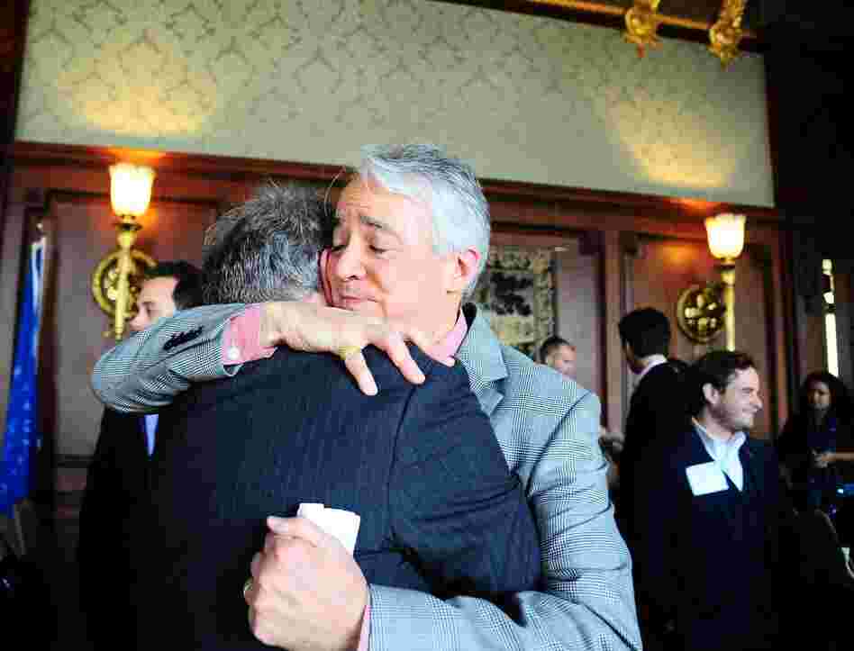 Following the Military Voices launch event, NPR Weekend Edition Saturday host Scott Simon hugs Gordon Bolar, General Manager of NPR Member Station WMUK in Kalamazoo, Michigan. In 2007, Bolar's son Matthew was killed by a roadside bomb in Iraq.
