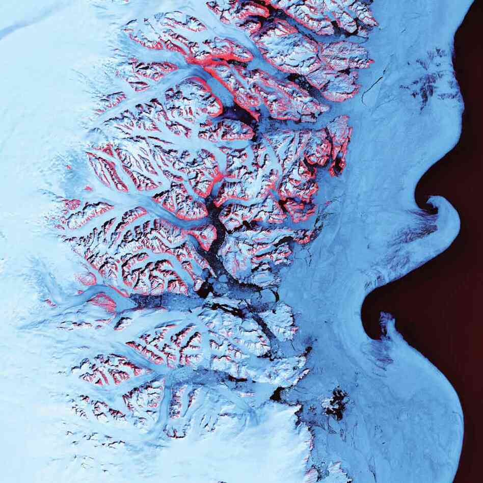 Ice Waves, Greenland, 2001The undulating swirls shown here along the eastern coast of Greenland are slurries of sea ice, newly calved icebergs, and older weathered bergs. During the summer melting season, the southward-flowing East Greenland Current twirls these mixtures into stunning shapes. The exposed rock of mountain peaks are tinted red.