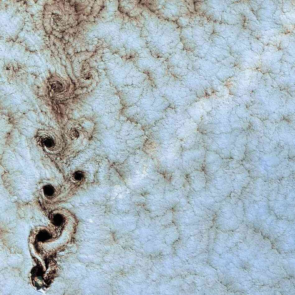 Von Kármán Vortices, Southern Pacific Ocean, 1999Swirling clouds line up in a formation known as a von Kármán street. They appear when wind-driven clouds encounter an obstacle, in this instance Alexander Selkirk Island in the southern Pacific Ocean.