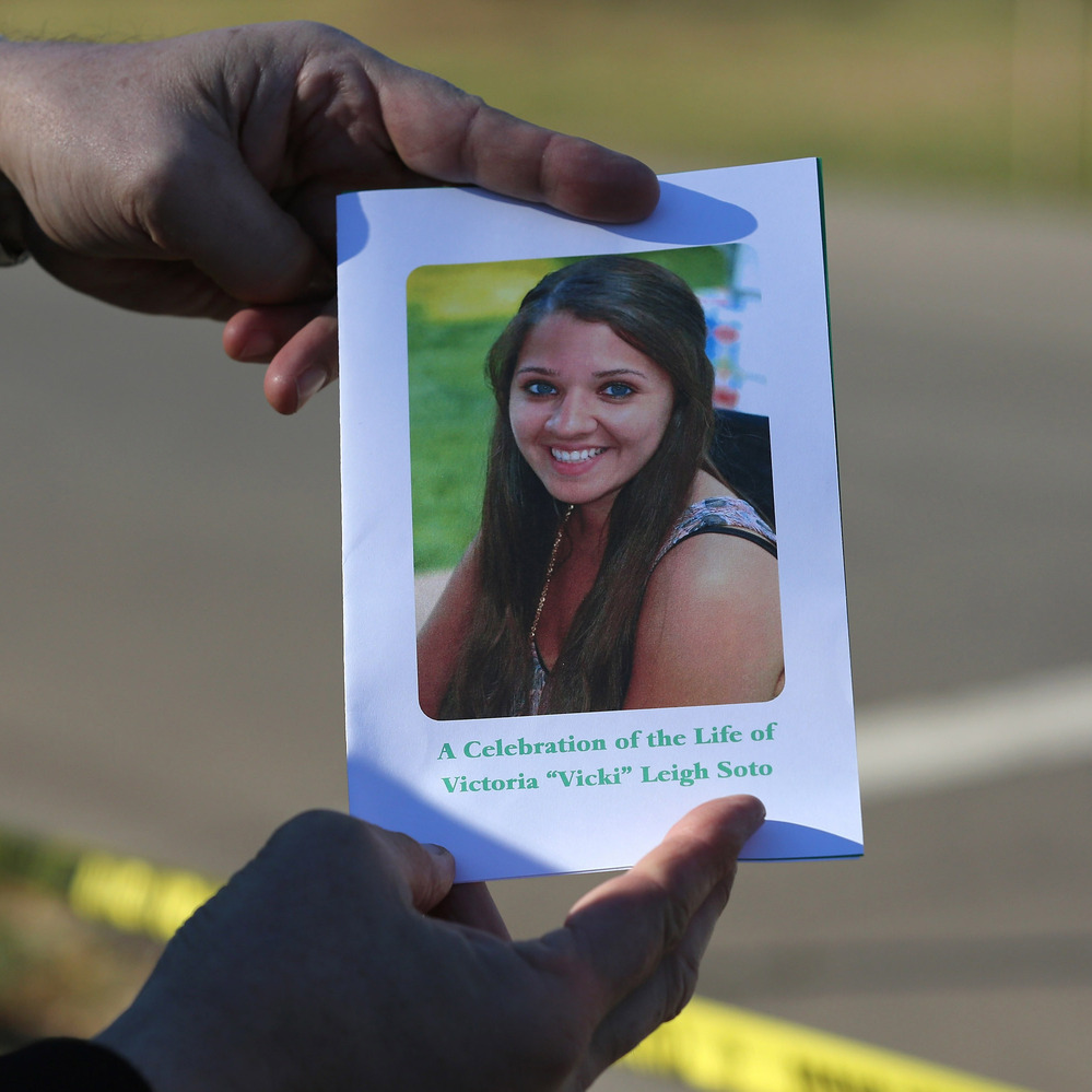 A mourner displays a program for the funeral of slain teacher Victoria Soto, 27, in Stratford, Conn.