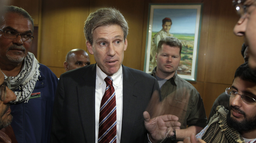 Chris Stevens speaks to the media in Benghazi, Libya, in 2011. Stevens, the U.S. ambassador to Libya, was killed on Sept. 11 of this year. Three U.S. government officials resigned Wednesday following a report that cited inadequate security.