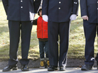 A child peers through firefighters standing as the procession heads to the cemetery outside the funeral for school shooting victim Daniel Barden at St. Rose of Lima Catholic Church in Newtown, Conn., A child peers through firefighters standing as the procession heads to the cemetery outside the funeral for school shooting victim Daniel Barden at St. Rose of Lima Catholic Church in Newtown, Conn.,