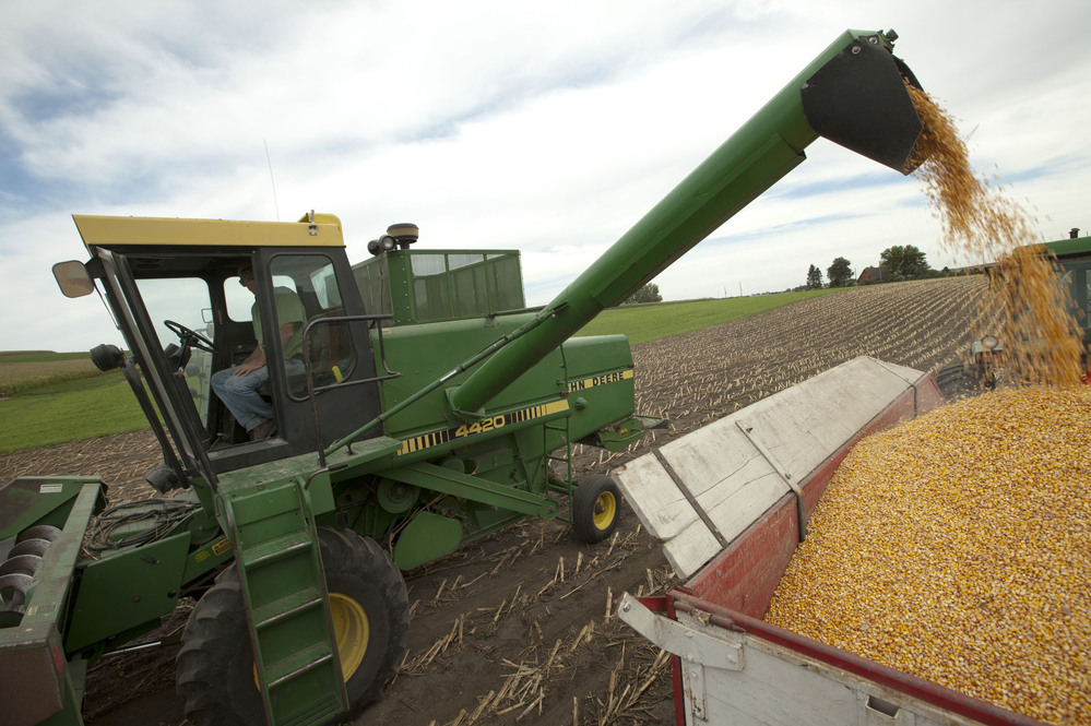 Farmer Randy Dreher unloads corn from his combine during harvest north of Audubon, Iowa. Farm exports are booming and high global prices are helping growers despite the U.S. drought.