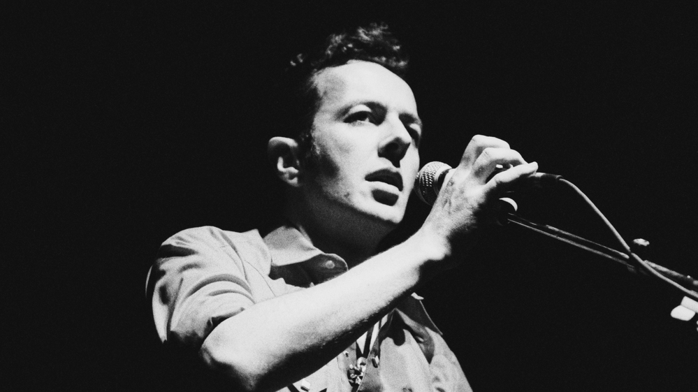 Joe Strummer performs with his solo project, The Latino Rockabilly War, in 1989. The Clash frontman died of heart failure in December 2002.