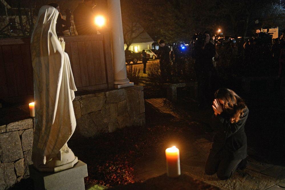 People gather for a prayer vigil at St. Rose Church in Newtown, Conn., on Dec. 14. In the aftermath of such tragedies, many people ask how a benevolent God and suffering can coexist.