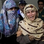 Rukhsana Bibi (center) mourns for her daughter, polio worker Madiha Bibi, killed by unknown gunmen, at a local hospital in Karachi on Tuesday. Gunmen staged additional attacks Wednesday.