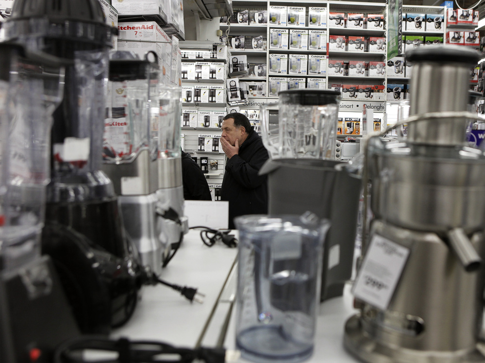 A man takes a closer look at kitchen appliances while shopping inside of a Bed Bath Bath & Beyond store in New York.