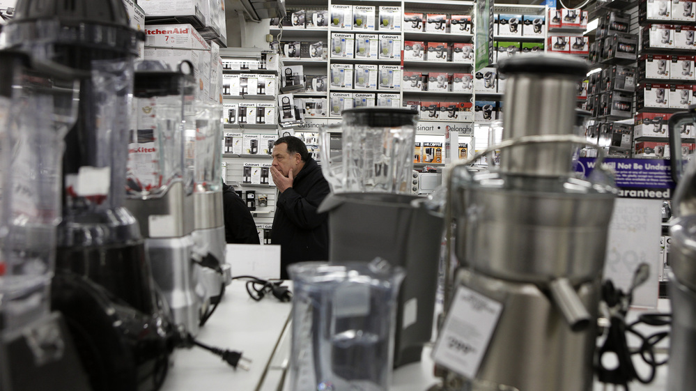 A man takes a closer look at kitchen appliances while shopping at a Bed Bath & Beyond store in New York.