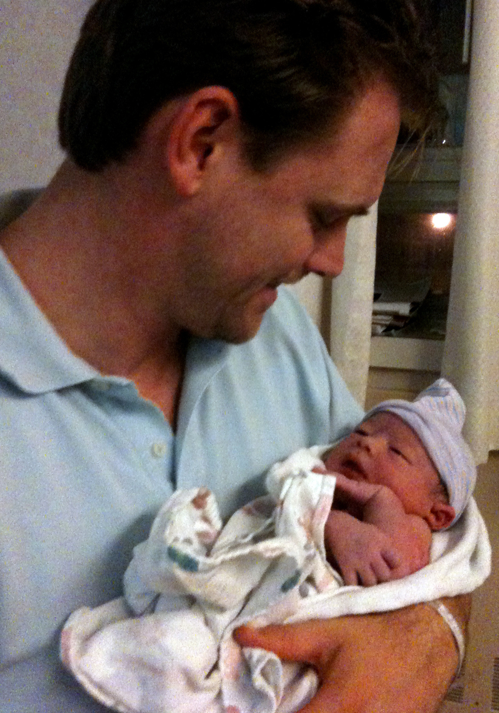 Kristian Aspelin cradles his newborn son, Johan.