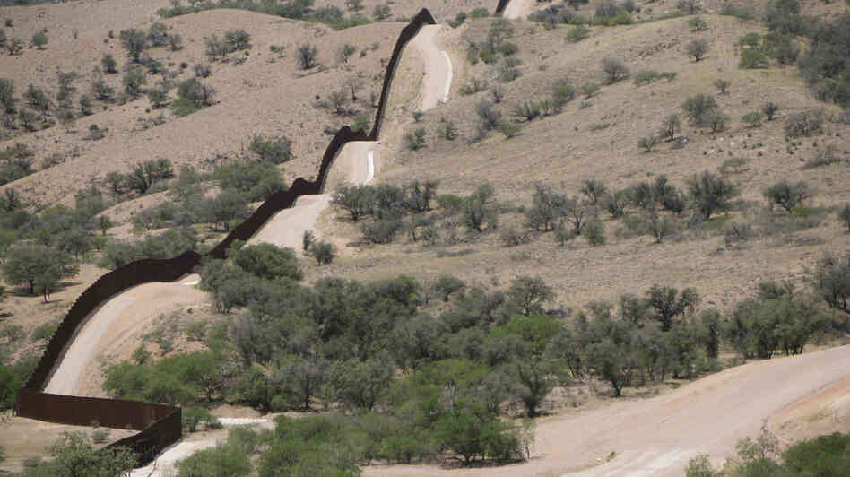 A hilltop view of the 18-foot fence along the U.S.-Mexico border west of Nogales, Ariz.
