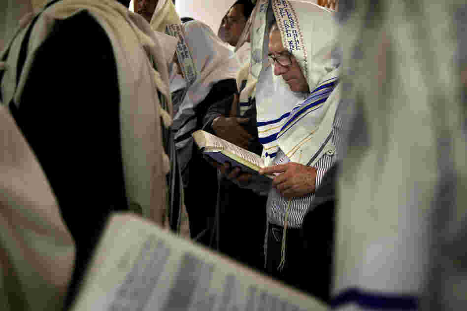 A man worships at the synagogue in Bello using a prayer book, the Siddur Birkat Shelomo, in which Spanish, Hebrew and phonetic versions are offered.