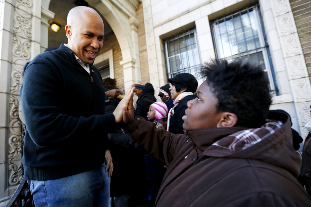 Newark Mayor Cory Booker greets a 13-year-old at a relief center for those affected by Superstorm Sandy, in November.