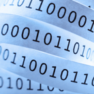 Tape with binary code close-up. Shallow DOF. Blue tone.