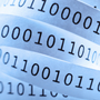 Tape with binary code close-up. Shallow DOF. Blue tone. Tape with binary code close-up. Shallow DOF. Blue tone.