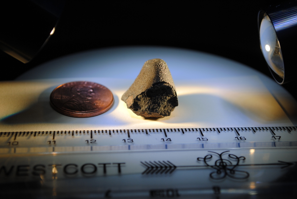 A section of the Sutter's Mill meteorite, dubbed "Darth Vader," is studied at a lab at the University of California, Davis. The meteorite is made of carbonaceous chondrite, which contains materials that formed the planets of the solar system.