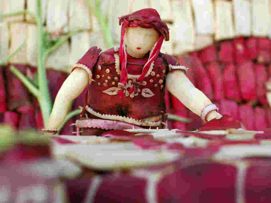 This radish woman appears to be making tortillas.