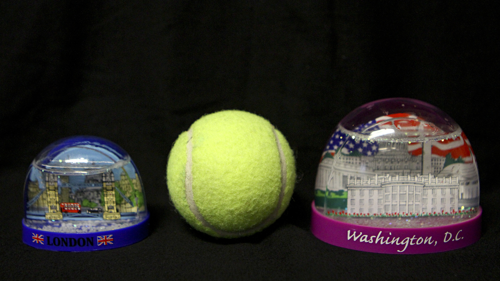 One of these snow globes doesn't belong onboard. The one on the left, which is about the size of a tennis ball, is permitted in your carry-on luggage. The one on the right is not.