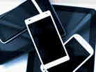 A pile of mobile phones and digital tablets.