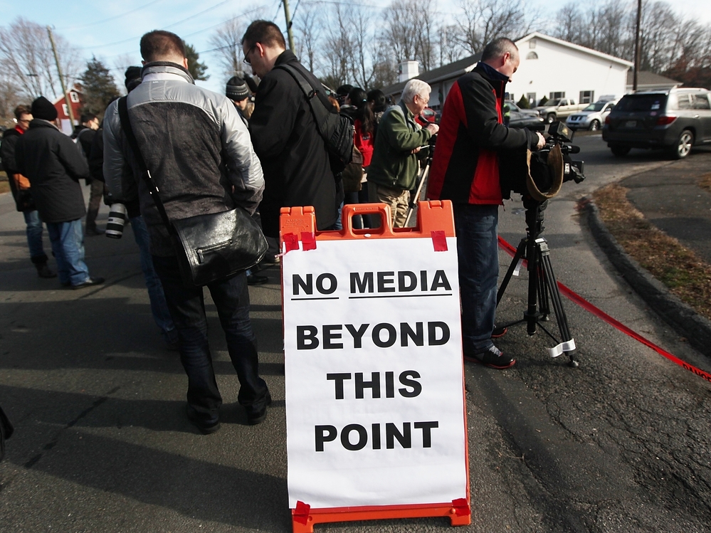 Media gather in Newtown, Conn. on Dec. 15, 2012 as the community copes with the elementary school shooting.