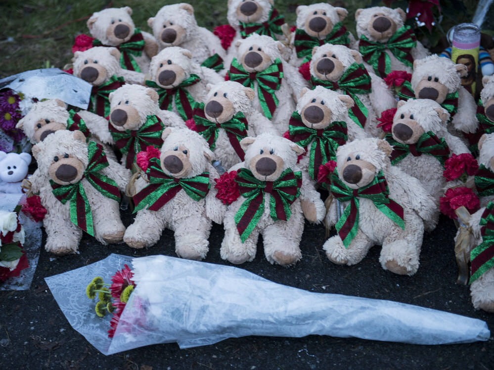 Stuffed animals and flowers at a makeshift memorial near the entrance to the grounds of Sandy Hook Elementary School.