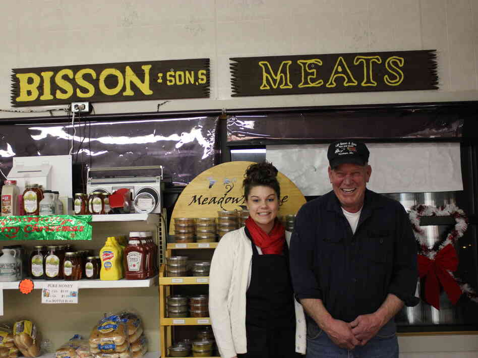 Robert Bisson of Bisson and Sons Meat Market in Topsham, Maine, with his granddaughter. The butcher shop sells traditional cretons during the holidays.