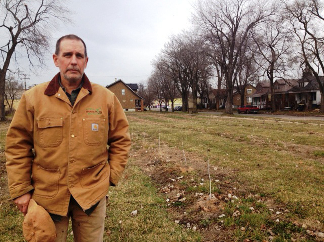 Mike Score, president of Hantz Farms, shows off a small-scare version of what Hantz Woodlands will look like.