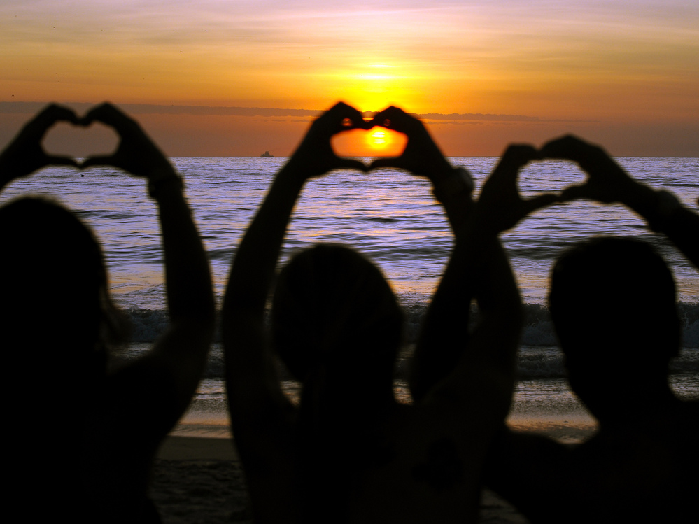 This morning on a beach in Brazil, some celebrated summer's first day — and the news that the world didn't end.