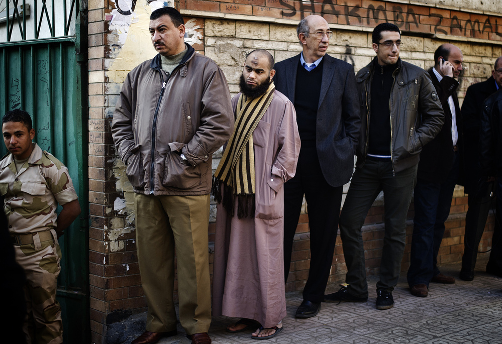 Egyptians wait in line to vote on a new draft constitution in Giza, south of Cairo, on Saturday. Egyptians wait in line to vote on a new draft constitution in Giza, south of Cairo, on Saturday.