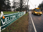 A school bus drives past a welcome sign near the Chalk Hill Middle School in Monroe, Conn. Students from Sandy Hook Elementary in neighboring Newtown will attend the school in January. A school bus drives past a welcome sign near the Chalk Hill Middle School in Monroe, Conn. Students from Sandy Hook Elementary in neighboring Newtown will attend the school in January.