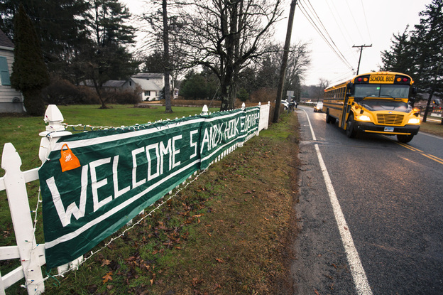 A school bus drives past a welcome sign near the Chalk Hill Middle School in Monroe, Conn. Students from Sandy Hook Elementary in neighboring Newtown will attend the school in January.