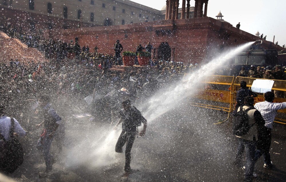 A water cannon targets protesters during their march towards the Presidential Palace in New Delhi, India, on Saturday.